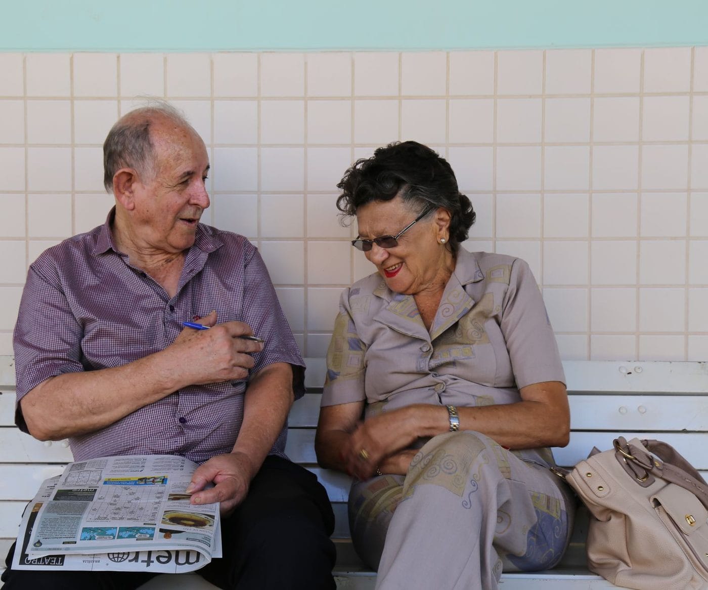 Casal de aposentados conversando num banco